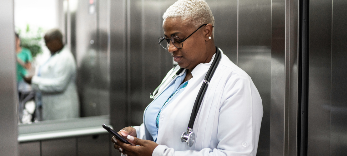 A doctor checks messages via her secure messaging app.